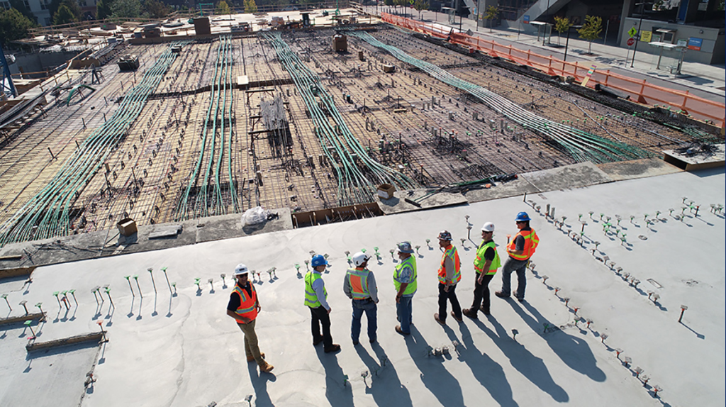 Illustration for an article on Value Stream Maps in the construction industry. Photo of an engineering team on a construction site.