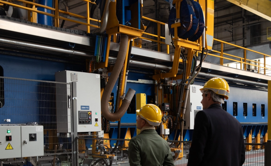 Work team on an automated production line illustrating the impact of innovation and digitalization on the industrial workforce.